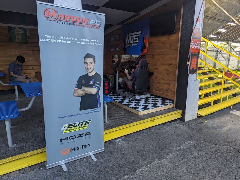Load image into Gallery viewer, Michael Conti - iRacing NASCAR Cup coach, on a MARDON banner at Oswego Speedway
